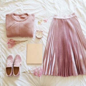 Flat lay of female summer outfit pink pastel color. Blogger lifestyle